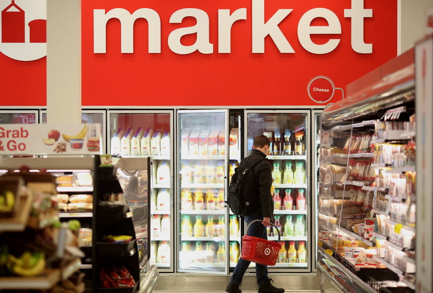 A customer picked up orange juice at the Target Express in Dinkytown. ] (KYNDELL HARKNESS/STAR TRIBUNE) kyndell.harkness@startribune.com At two different Target Stores. One in the Quarry and the second is at the Target Express in Dinkytown in Minneapolis, Min., Wednesday, February 4, 2015.