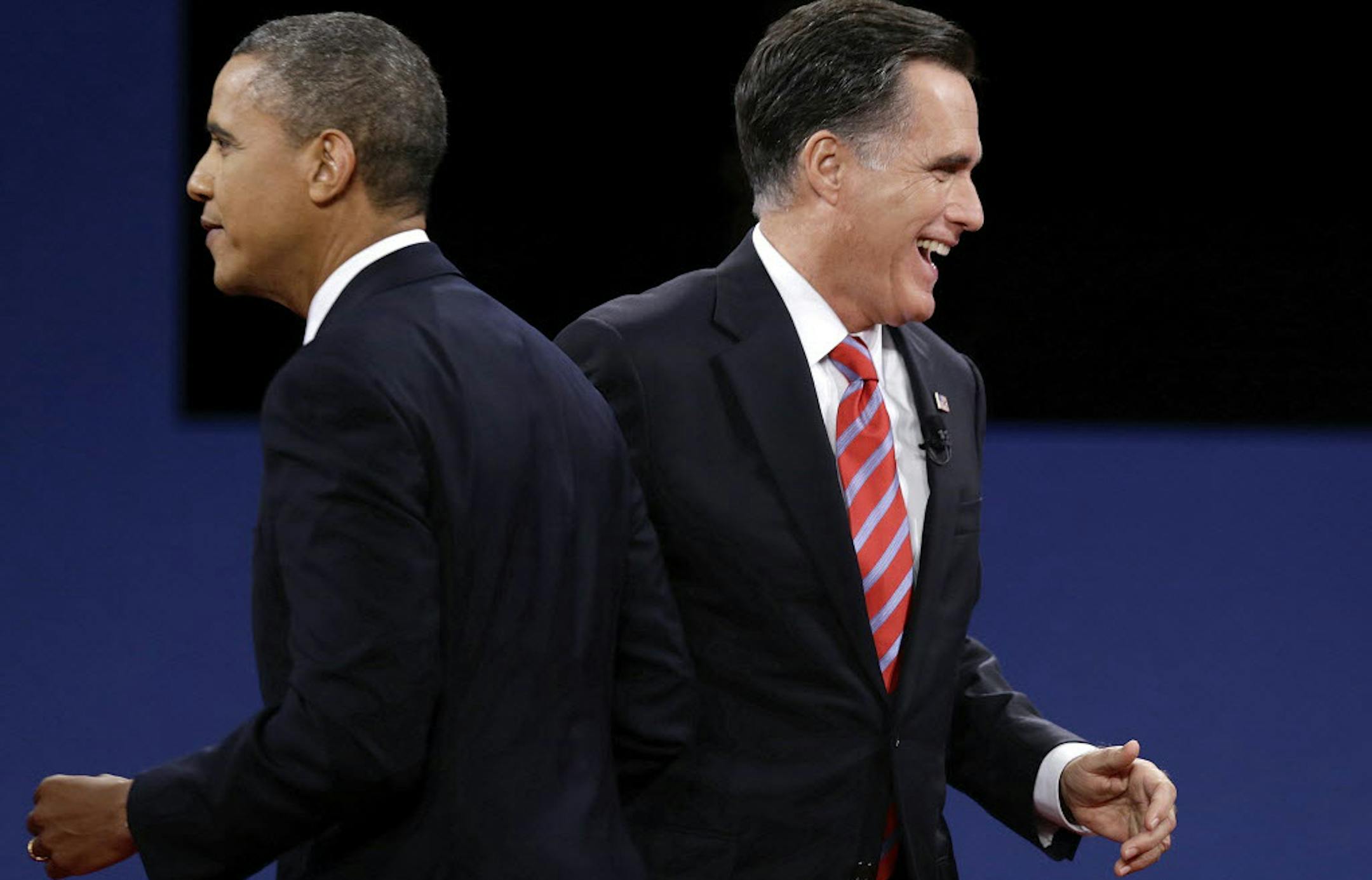 President Barack Obama and Republican presidential nominee Mitt Romney pass each other after the third presidential debate.