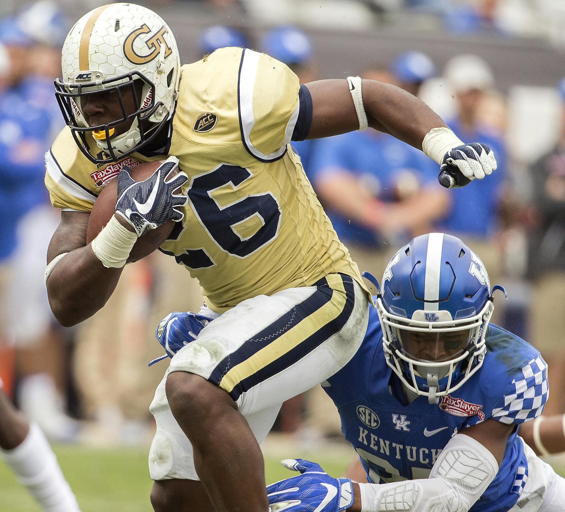 Georgia Tech running back Dedrick Mills (26) is tackled by Kentucky safety Mike Edwards (27) during the second half of the TaxSlayer Bowl NCAA college football game, Saturday, Dec. 31, 2016, in Jacksonville, Fla. Georgia Tech beat Kentucky 33-18. (AP Photo/Stephen B. Morton)