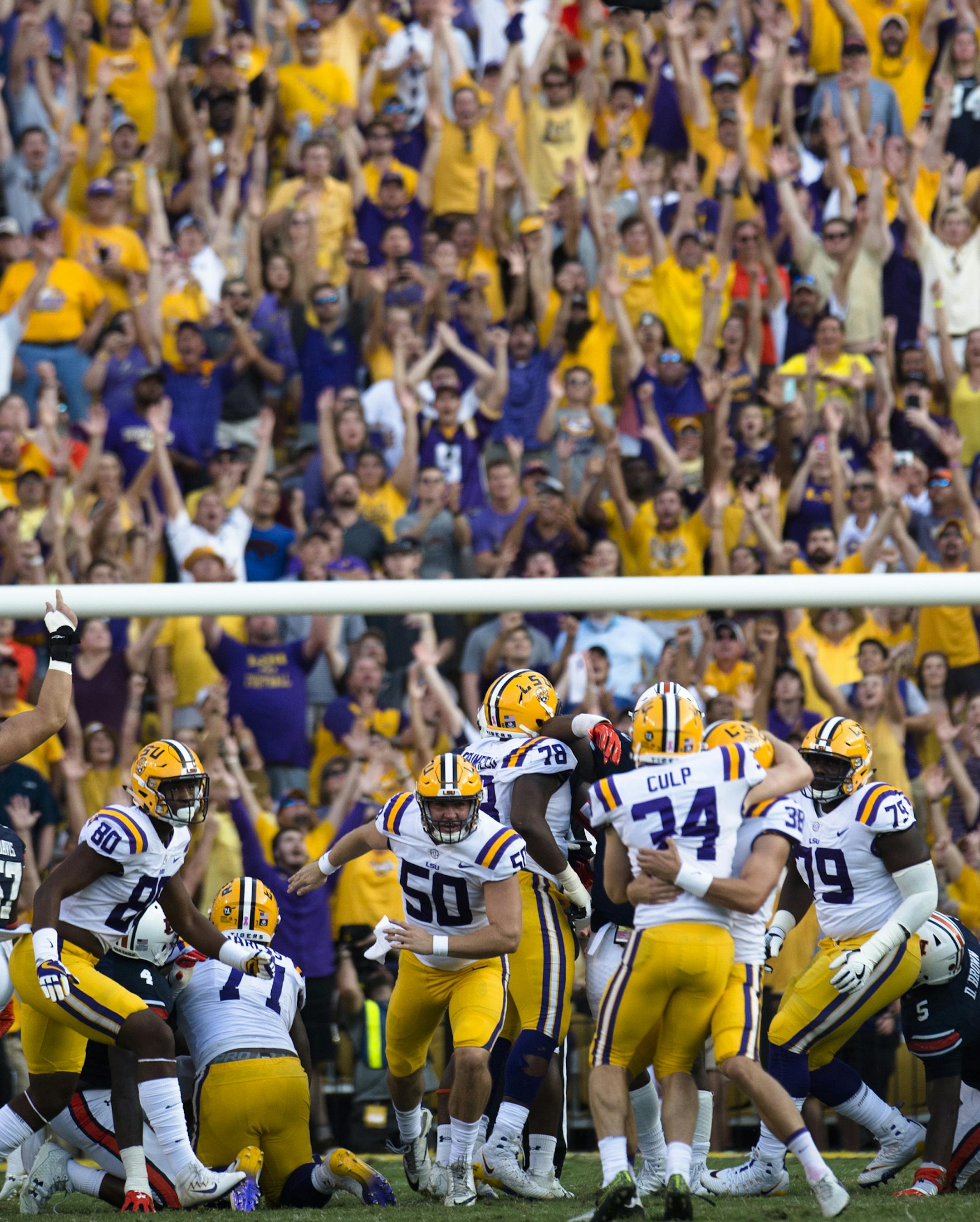 LSU place kicker Connor Culp (34) celebrates with Josh Growden (38) after kicking a field goal giving LSU its first lead of the game against Auburn in the second half of an NCAA college football game against Auburn in Baton Rouge, La., Saturday, Oct. 14, 2017. LSU won 27-23. (Albert Cesare/The Montgomery Advertiser via AP)