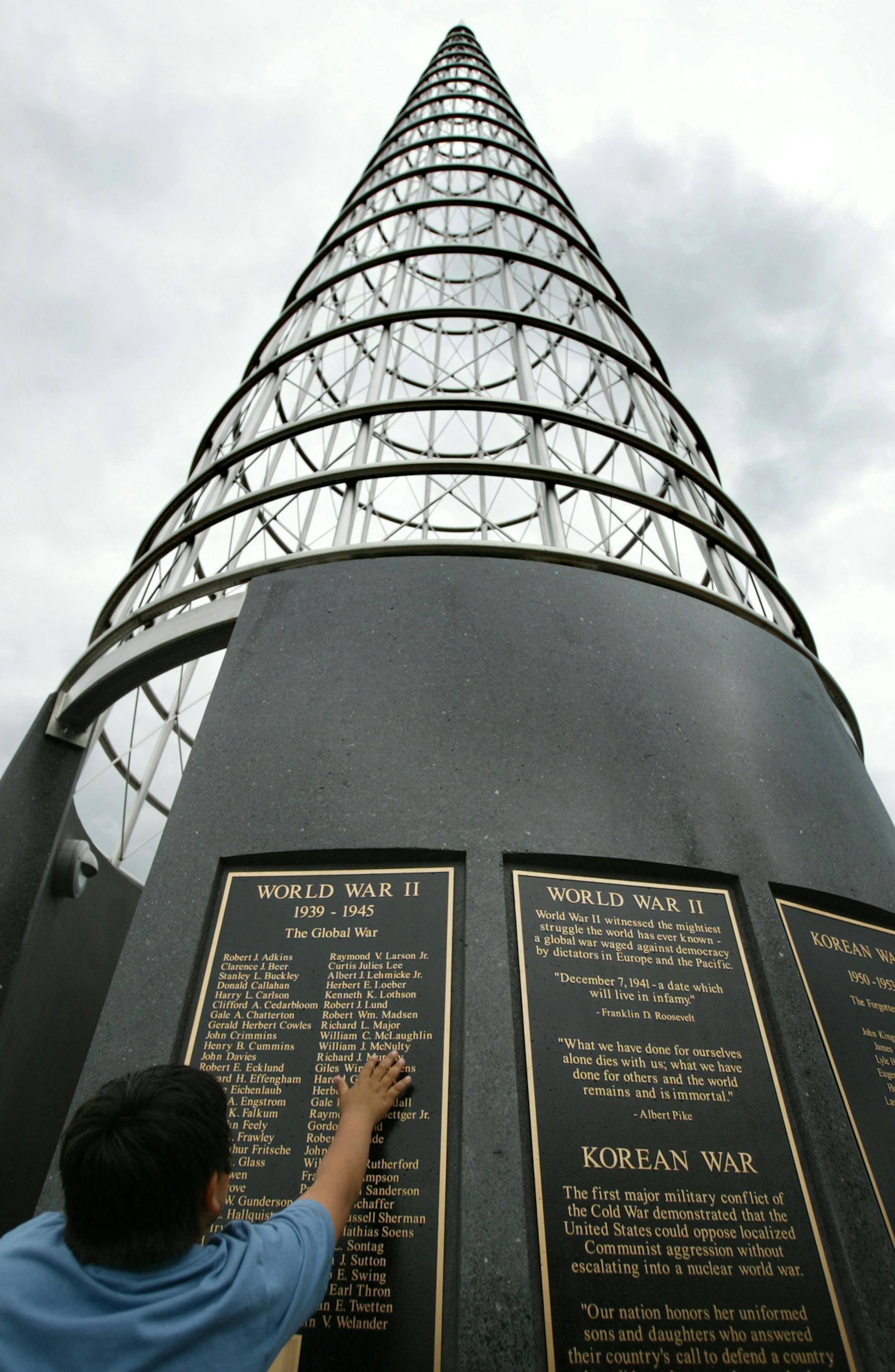 Eight-year-old Jay Hering, of Stillwater, searches for his grandfather's name, William Hering, on the newly dedicated Veterans Memorial in Stillwater. ORG XMIT: MIN2013073110131412