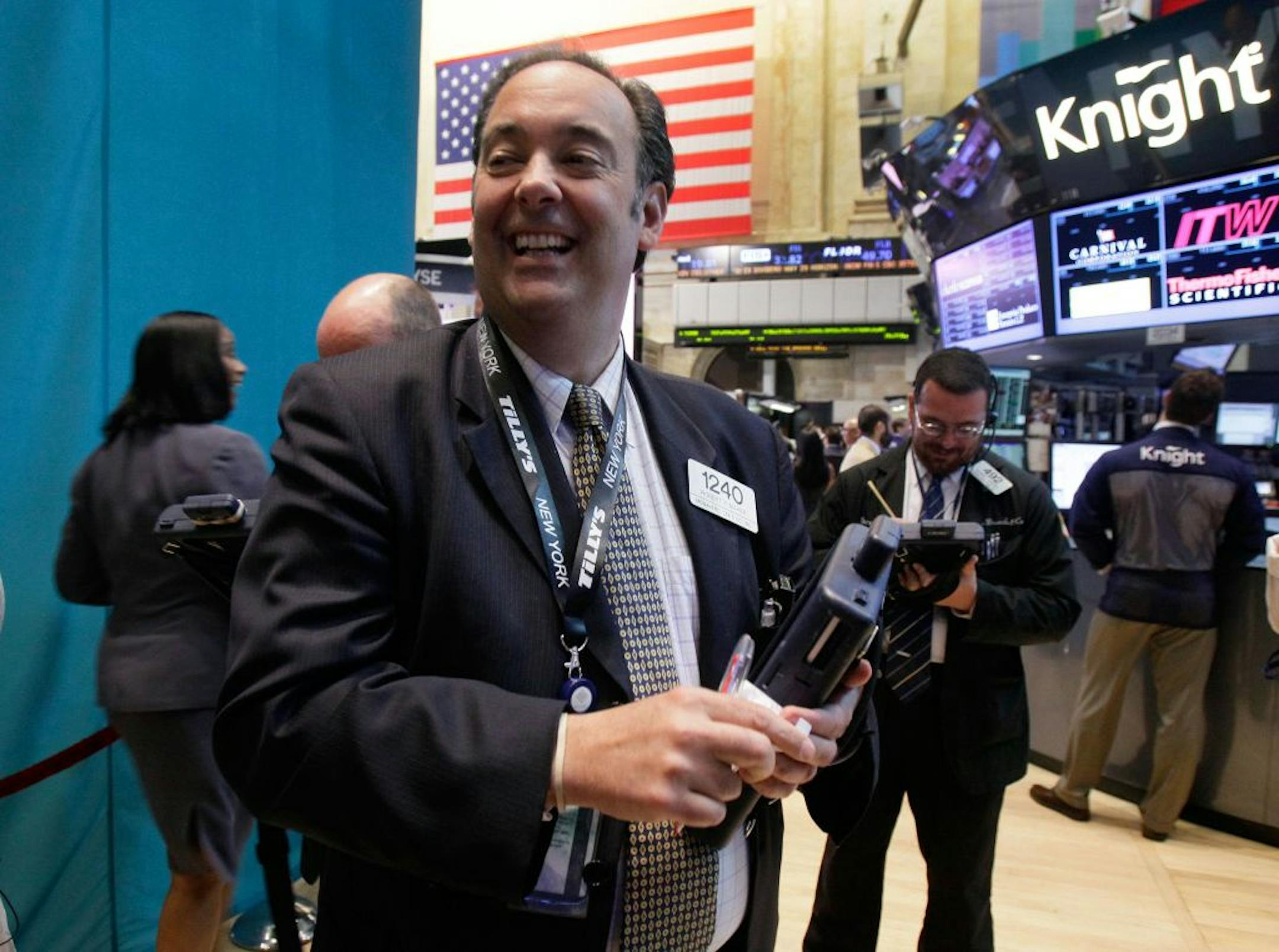 Why is this man smiling? Well, things were pretty good on the New York Stock Exchange Tuesday. The Dow closed up almost 126 points as worries about Greece abated – for the moment, anyway.