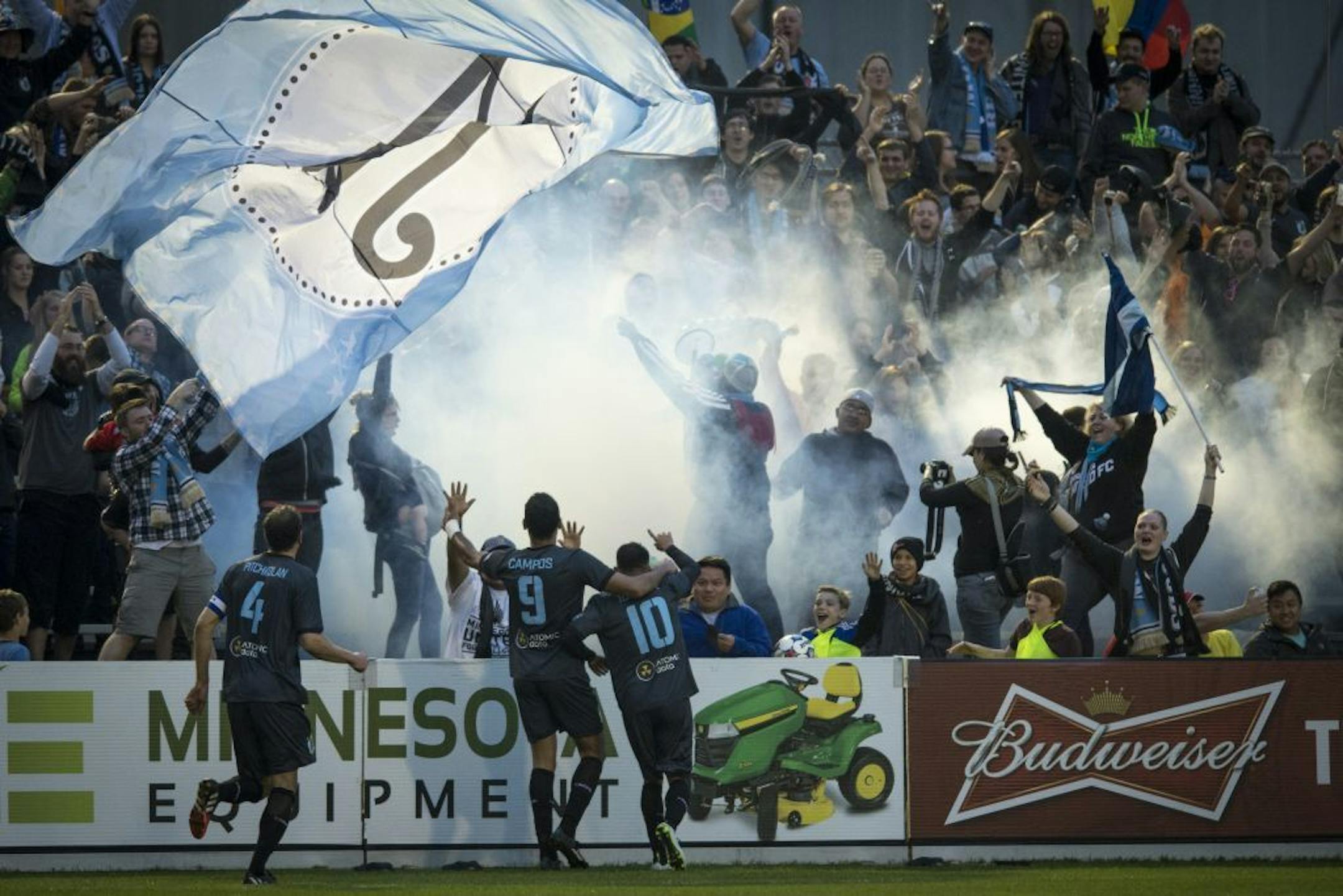 Minnesota United FC's Aaron Pitchkolan (4), Pablo Campos (9) and Miguel Ibarra (10) celebrated a goal by Ibarra with fans during the second half against Jacksonville Armada FC Saturday night.