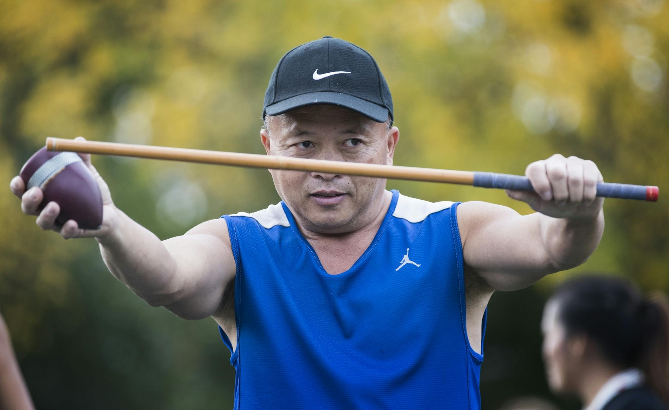 Young Vang demonstrates the game of Tuj Lub.