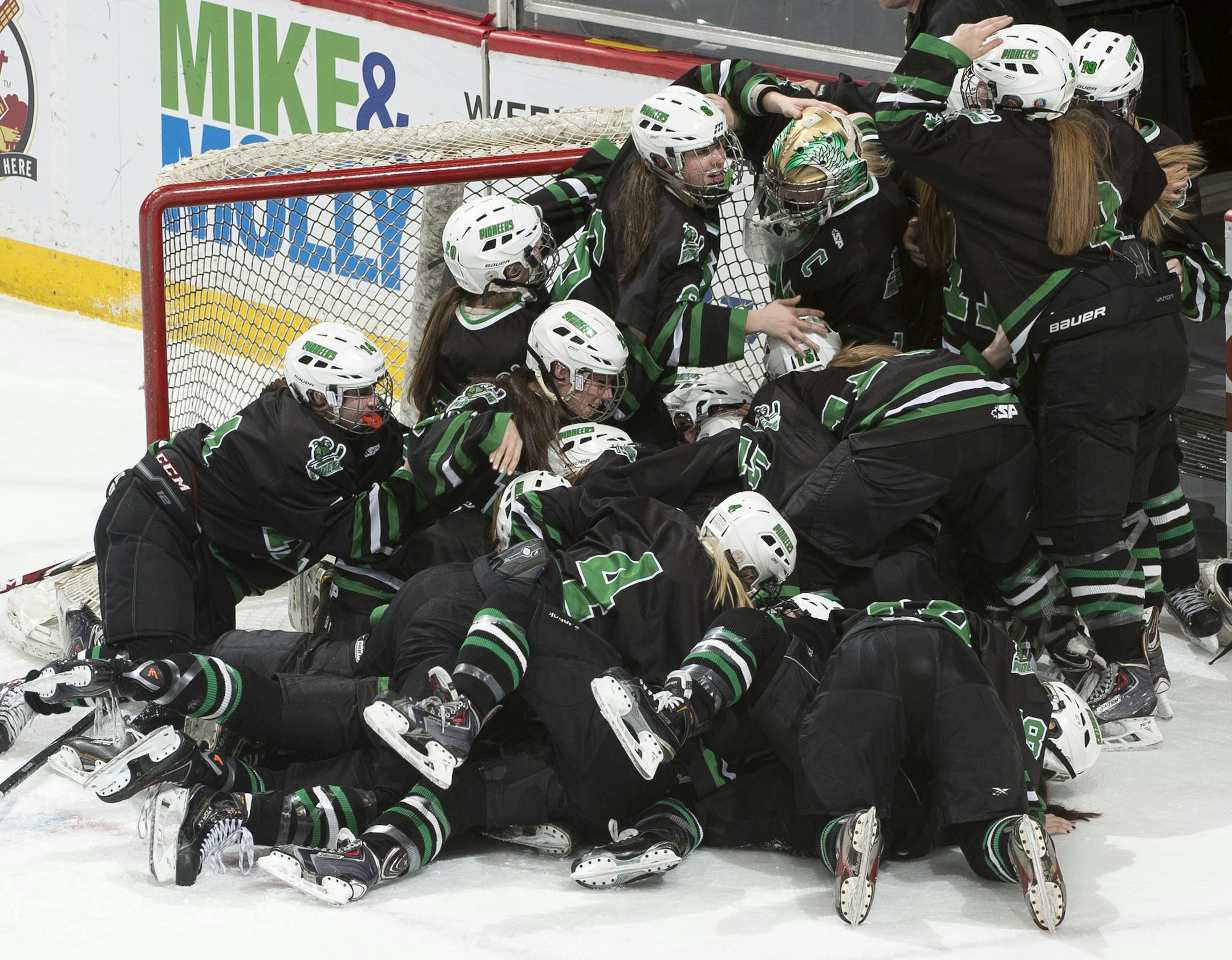 Hill-Murray players pile on top one another while celebrating their 2-1 victory over Minnetonka in the Class 2A Girls' Hockey Championship game. ] (Aaron Lavinsky | StarTribune) Hill-Murray plays Minnetonka in the Class 2A Girls' Hockey Championship game on Saturday, Feb. 21, 2015 at Xcel Energy Center in St. Paul.
