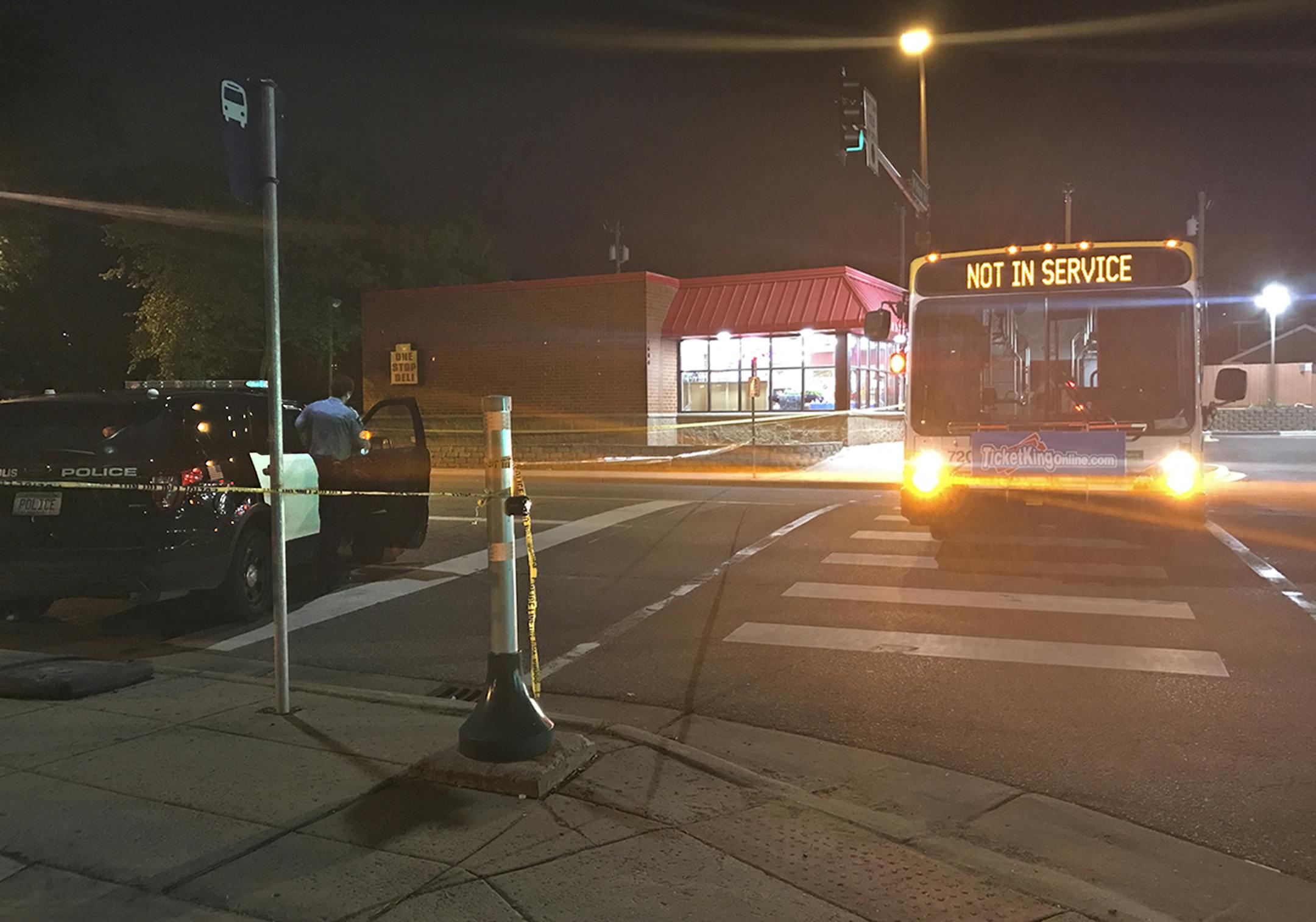 Police used a Metro Transit bus to block the intersection of Knox Av. N. and W. Broadway Ave. in Minneapolis, near scene where a an adult male was found fatally shot in a car Monday evening. Two suspects are in custody in connection with the shooting, police said. Photo by Karen Zamora.