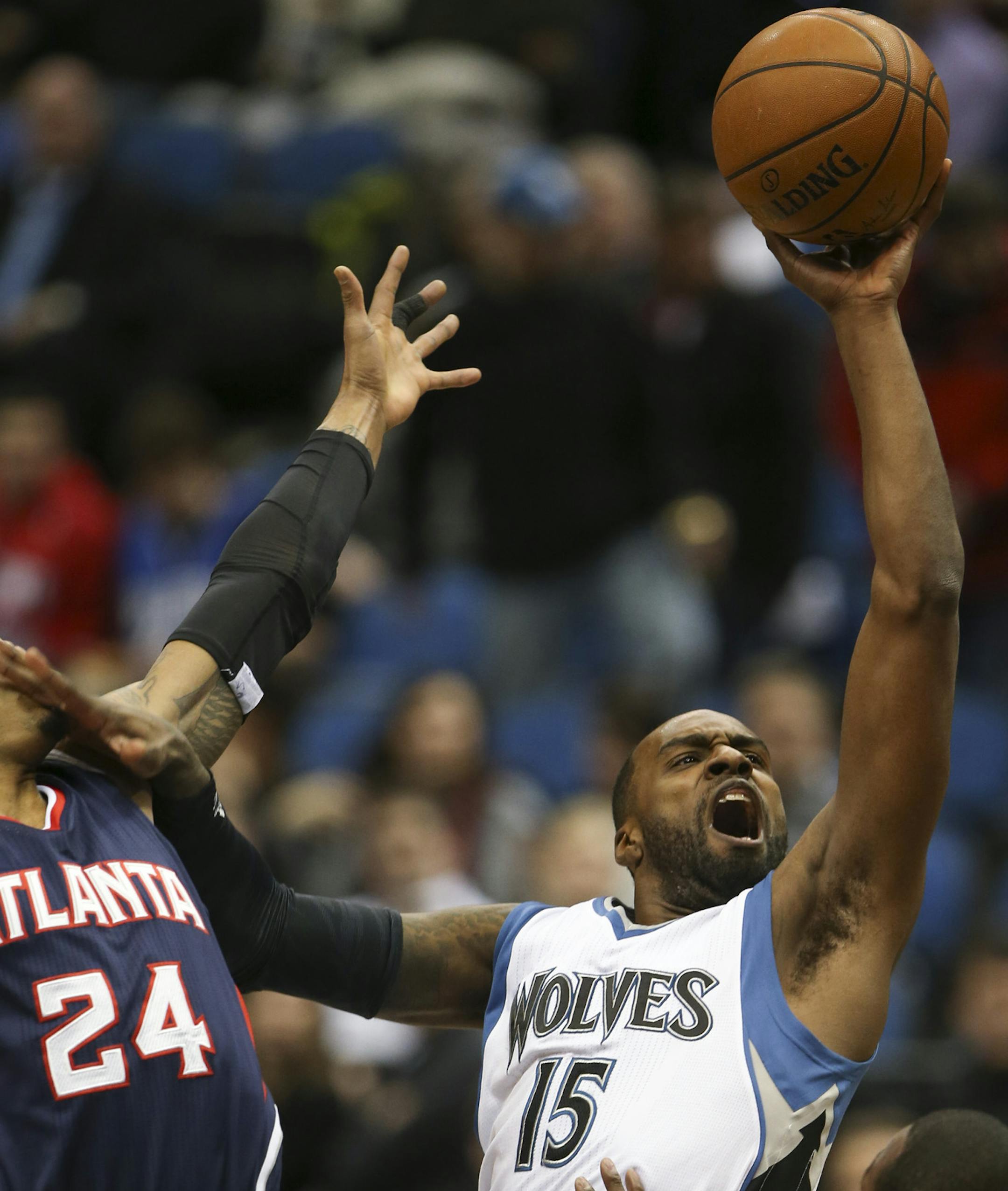 Timberwolves forward Shabazz Muhammad took a first-quarter shot against the Hawks' Kent Bazemore on Monday night at Target Center.