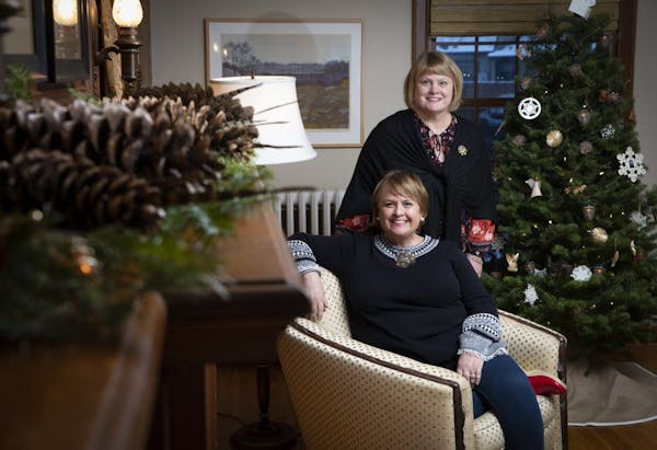 Liz Knutson, seated, and her sister Kathy Keehn in Knutson's Minneapolis home, which they decorated for the holidays. The designing sisters are partne