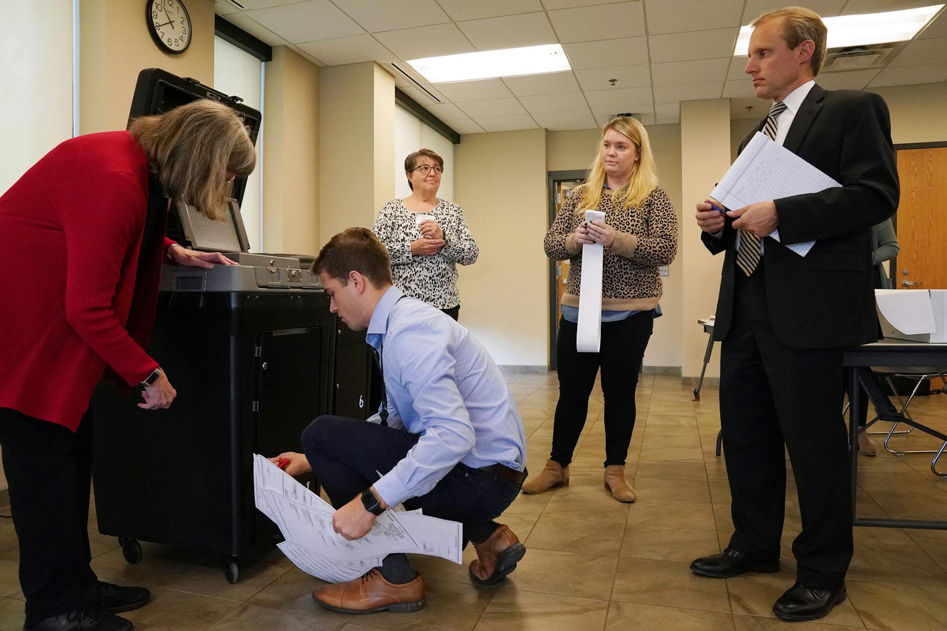 Minnesota Secretary of State Steve Simon, right, watched as elections officials worked on the mandatory public testing of St. Louis Park's voter machines before the 2018 midterm elections.