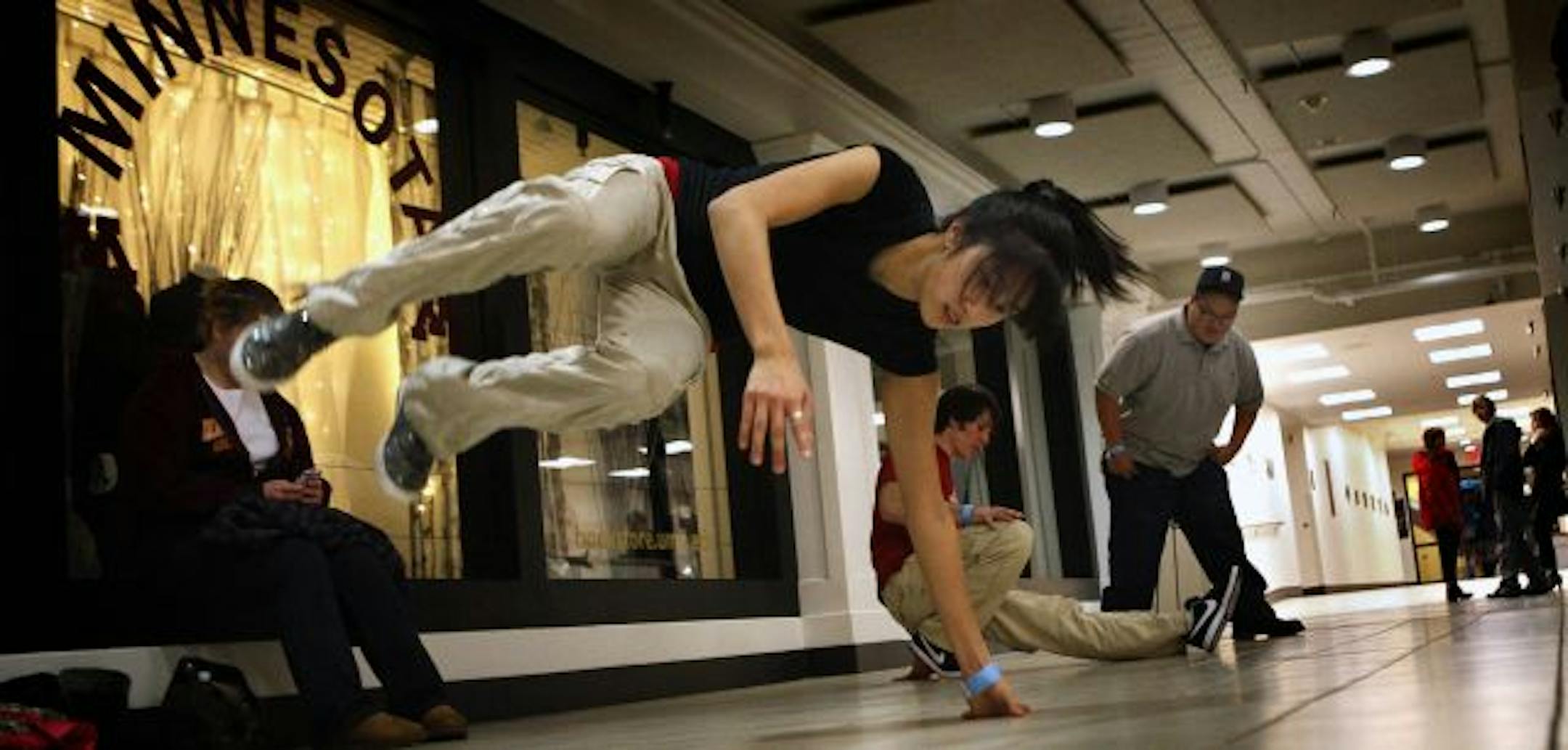 Helen Lin practiced some of her moves as other members of the breakdancing club at the U of M participated in the dancing demonstration.
