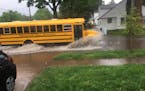 A school bus drives through flooding in the Cleveland neighborhood.