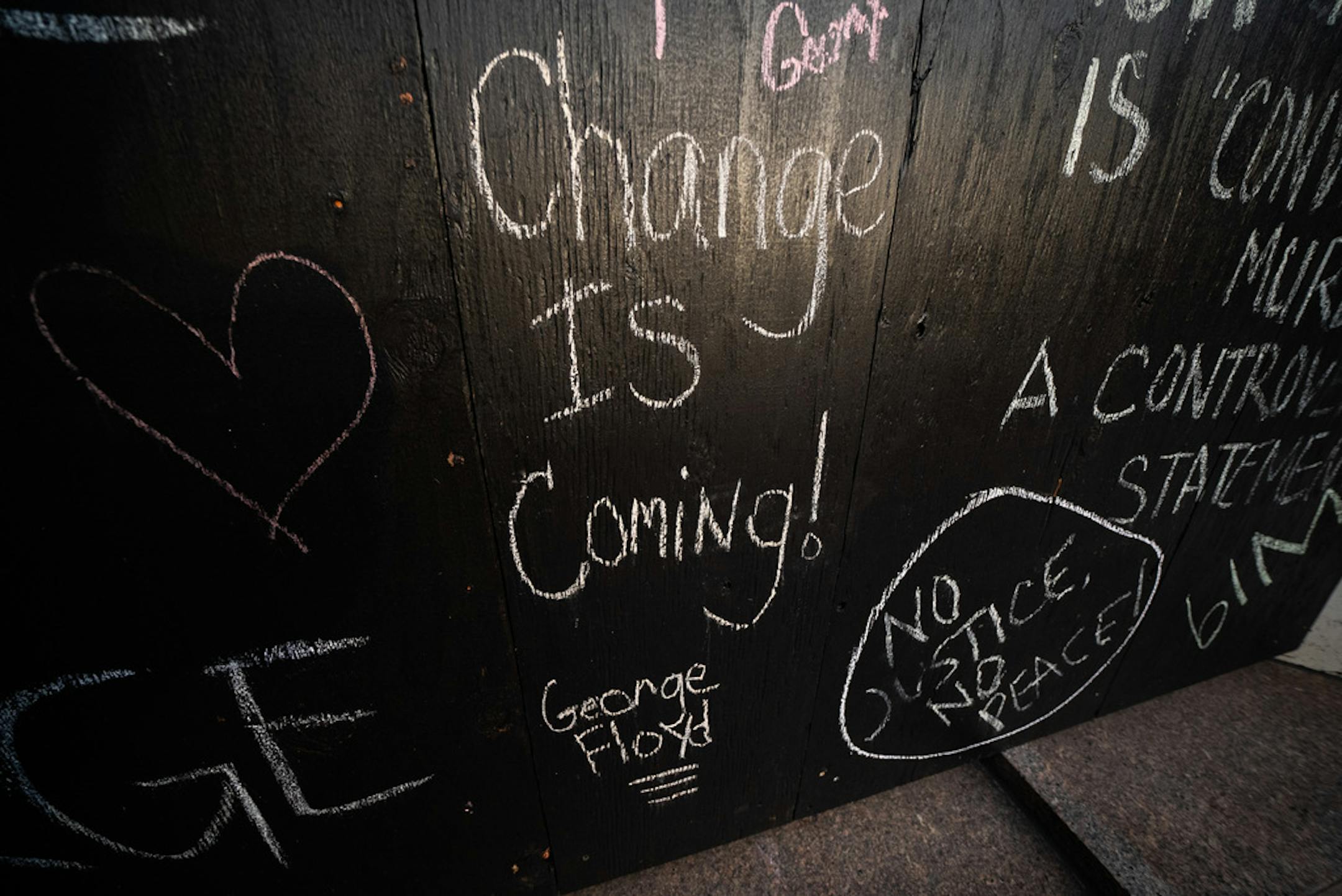 Chalk messages remained on the boarded up windows of and adjacent building.