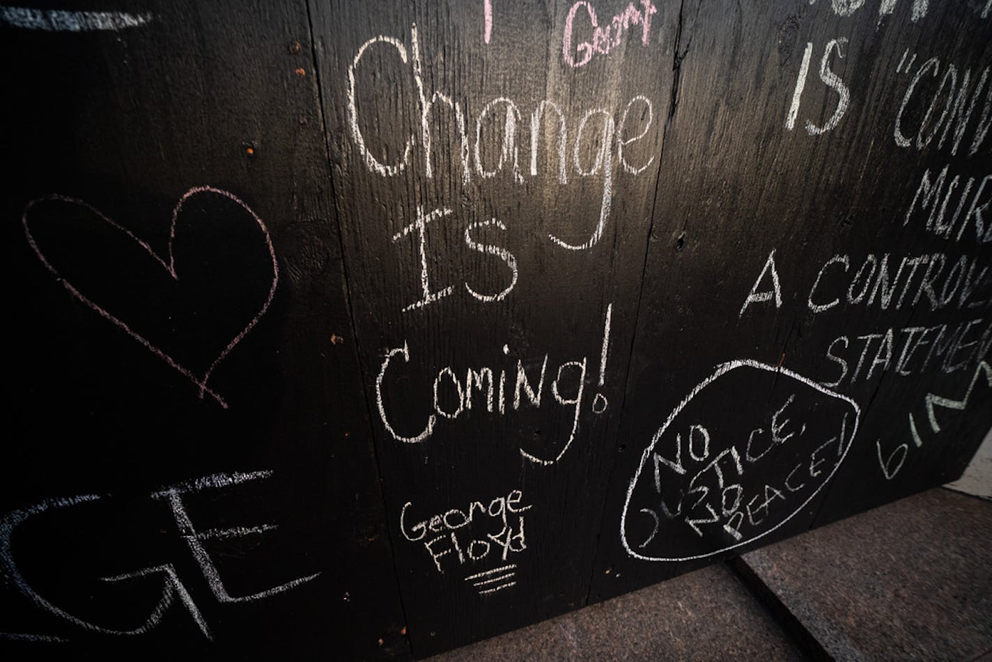 Chalk messages remained on the boarded up windows of and adjacent building.