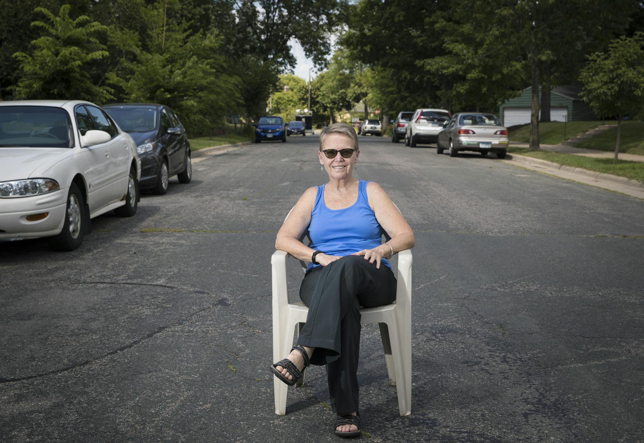 Eileen Kerr is organizing to attempt at something that hasn't been done for close to 40 years--closing a residential street to all but emergency traffic. Kerr and her neightbors' idea is to create a space where neighbors can mix, drink coffee, garden, and enjoy less asphalt. She sat in the middle of the road in front of her house on 45th Av. S. in Minneapolis, Minn., on Monday, July 18, 2016. ] RENEE JONES SCHNEIDER • reneejones@startribune.com