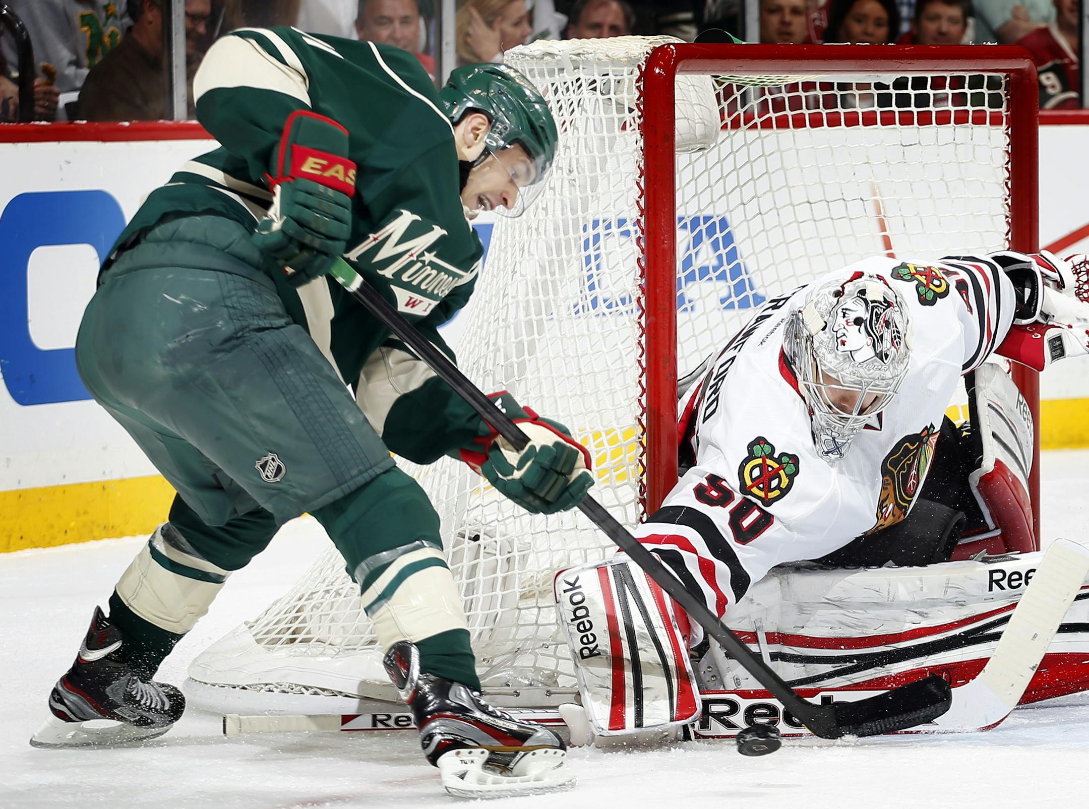 Zach Parise (11) handled the puck in front of the goal as Blackhawks goalie Corey Crawford (50) in the first period. ] CARLOS GONZALEZ cgonzalez@startribune.com May 7, 2013, St. Paul, Minn., Xcel Energy Center, NHL Stanley Cup Playoffs, quarterfinals, Minnesota Wild vs. Chicago Blackhawks, Game 4,