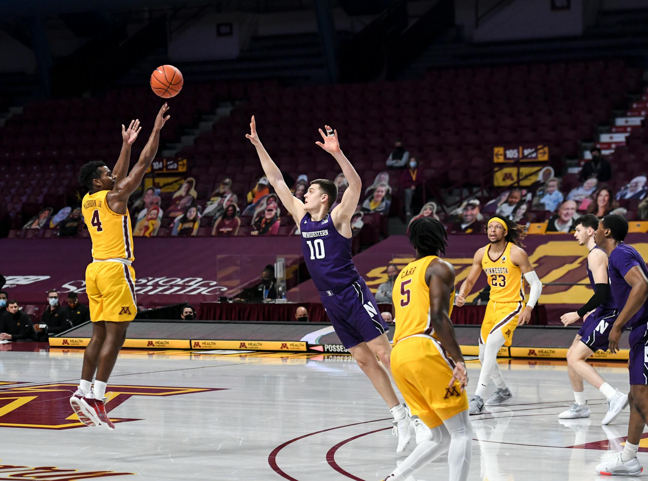 Minnesota Gophers guard Jamal Mashburn Jr. (4) scored a 3-pointer in the first half as Northwestern Wildcats forward Miller Kopp (10) defended.