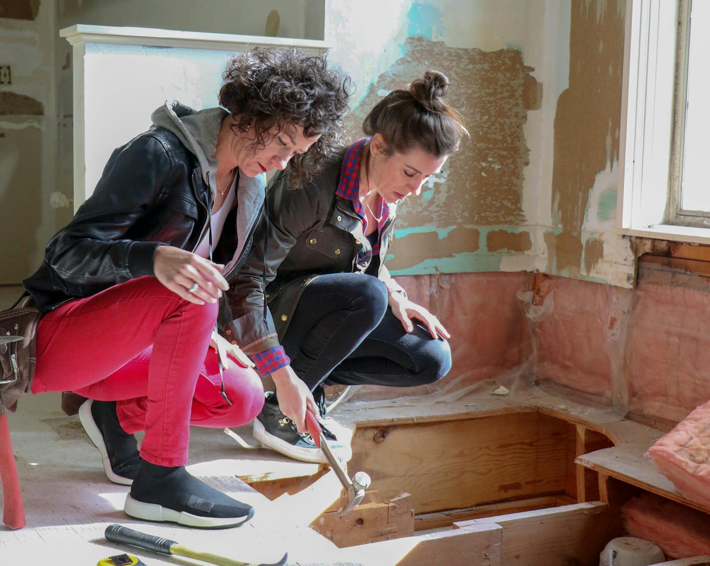 Lindsey and Kirsten in Ron and Sonia's bathroom post-demo, as seen on Renovation 911, Season 1.