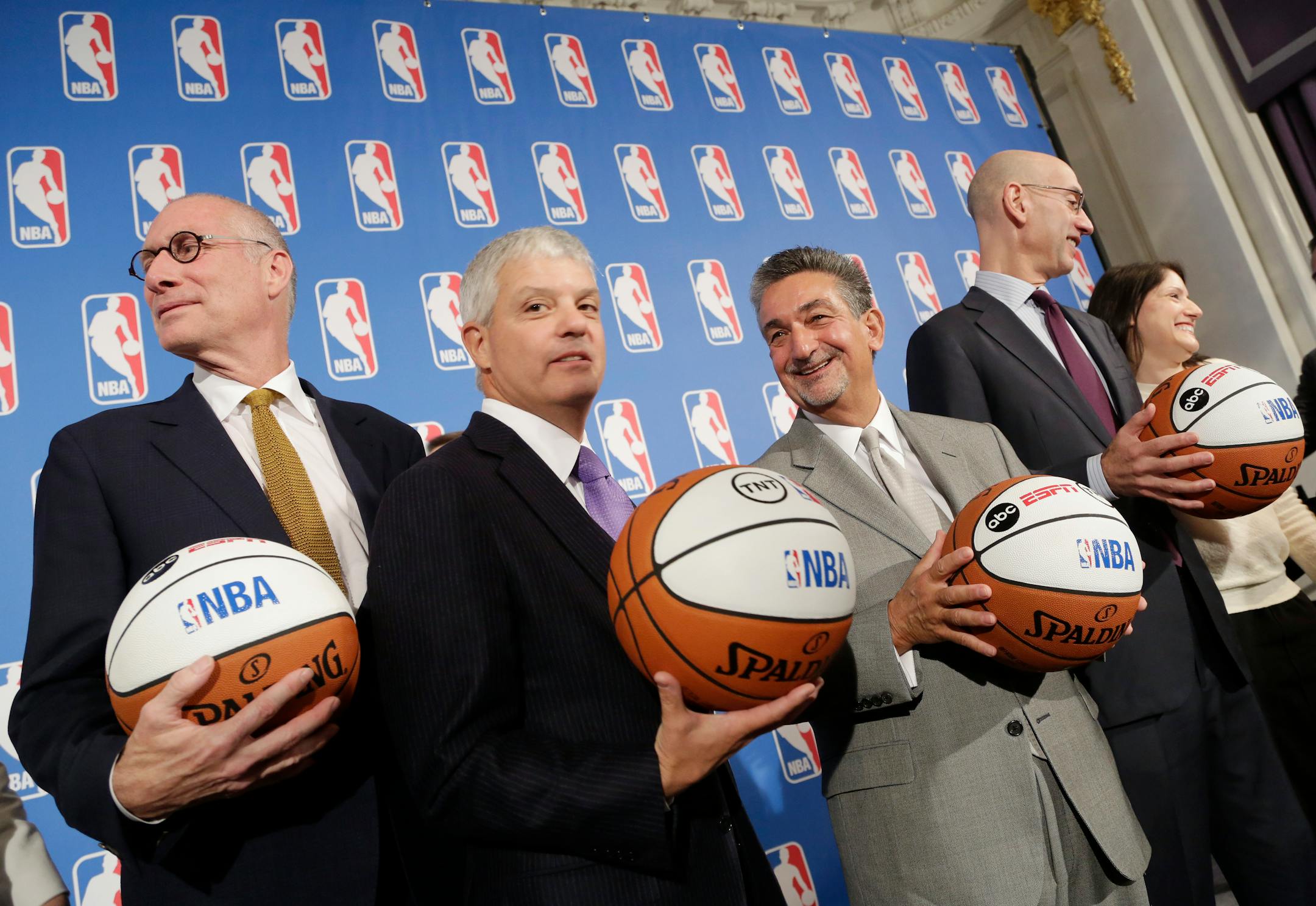 ESPN President John Skipper, left, David Levy, second left, President of Turner Broadcasting System, Ted Leonsis, second right, owner of the Washington Wizards, and NBA Commissioner Adam Silver, right, stand with basketballs for a portrait after a deal was announced between the league and TV networks, Monday, Oct. 6, 2014 in New York. The NBA has extended its television deals with ESPN and TNT for nine years. The league announced Monday that the new contracts will run through the 2024-25 season.