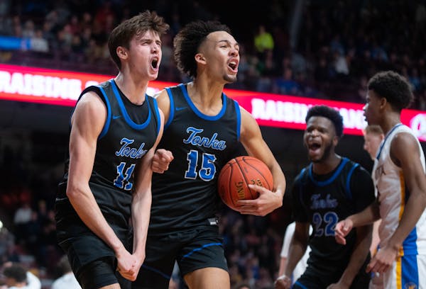Minnetonka guard Andy Stefonowicz (11) and forward Kayden Wells (15) celebrate a moment during the Skippers' state championship victory Saturday night