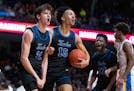 Minnetonka guard Andy Stefonowicz (11) and forward Kayden Wells (15) celebrate a moment during the Skippers' state championship victory Saturday night
