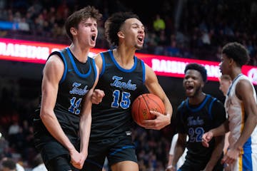 Minnetonka guard Andy Stefonowicz (11) and forward Kayden Wells (15) celebrate a moment during the Skippers' state championship victory Saturday night