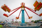 Fair employees test run one of the rides while setting up shop at the Minnesota State Fairgrounds' Midway Parkway. The fair opens to the public on Thu