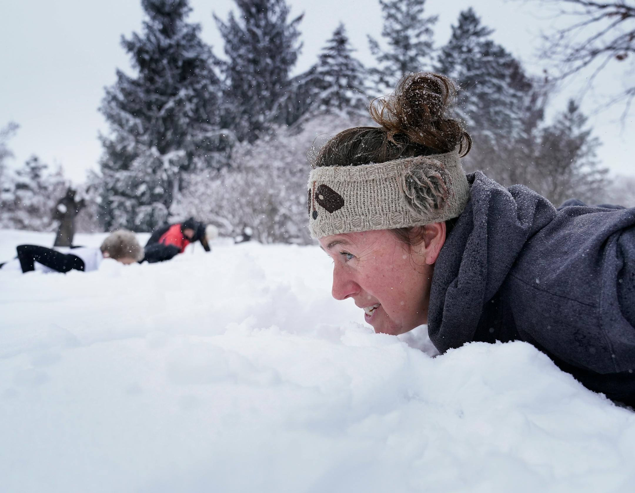 As part of the Yoga in the Gardens series, instructor Jenn Holm, right, of Yoga 4 You, was up to her chin in snow while leading participants in Snowga.