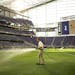 A groundskeeper watered the grass in U.S. Bank Stadium before Tuesday night's soccer match. Grass is cq.