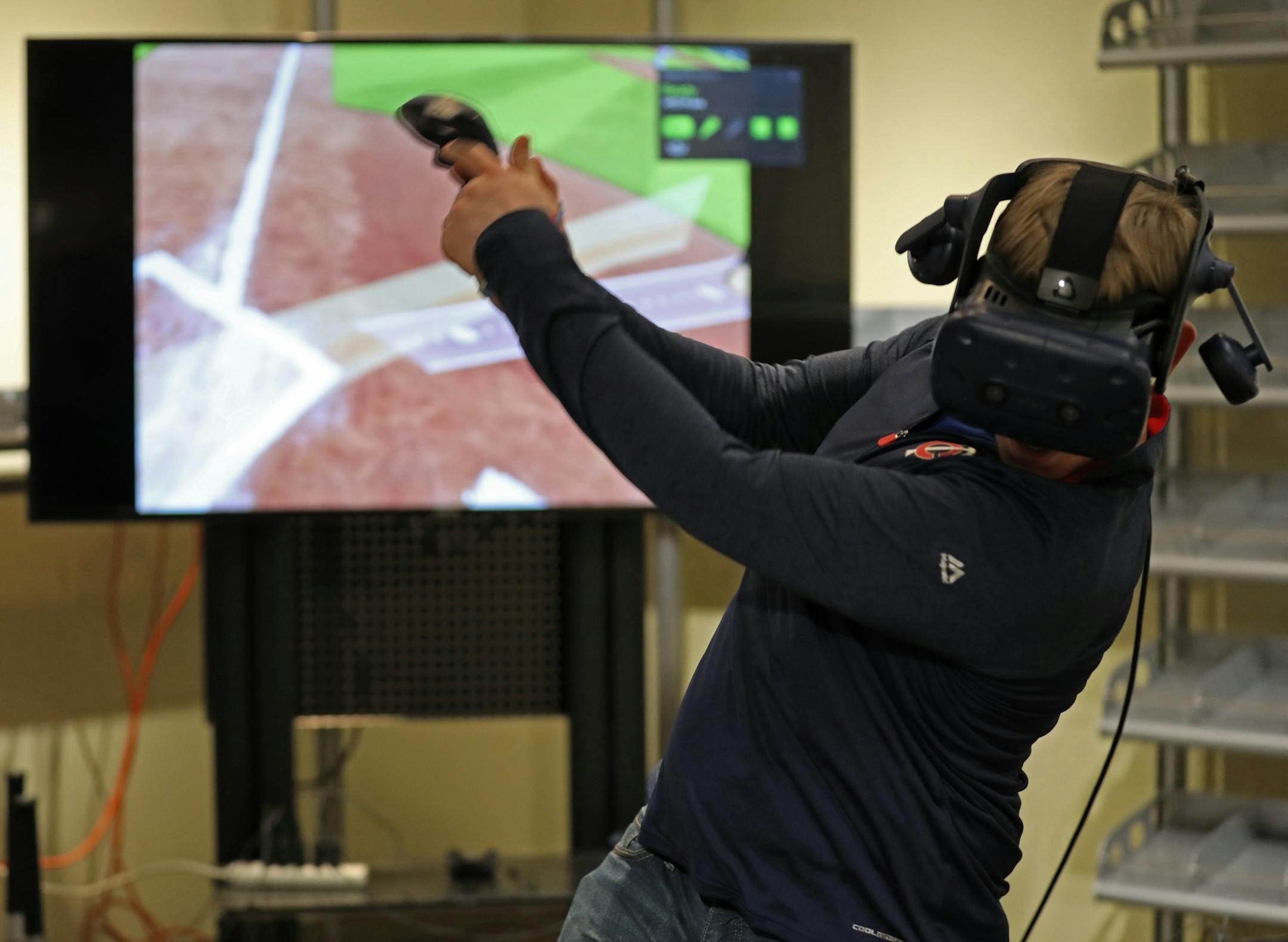 A fan tried his hand at hitting a pitch inside the virtual reality room at TwinsFest.