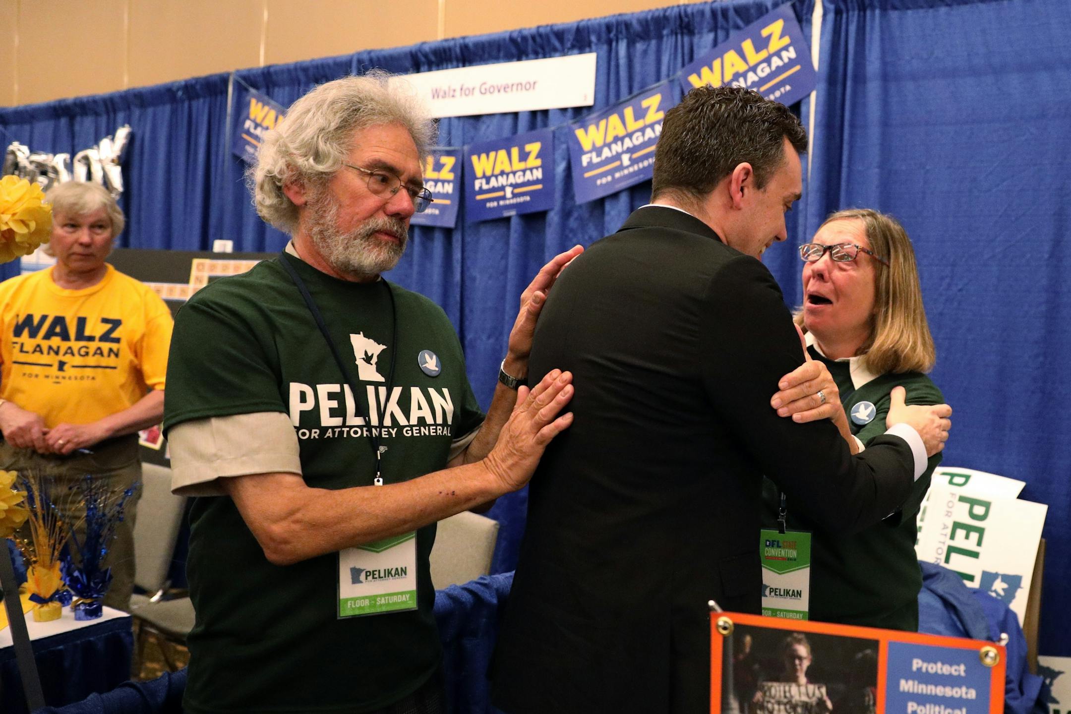 Attorney general candidate Matt Pelikan gave a hug to his mother Martha as his father Marty put his hand on his back after he accepted the party's endorsement when Minnesota attorney general Lori Swanson withdrew Saturday morning.