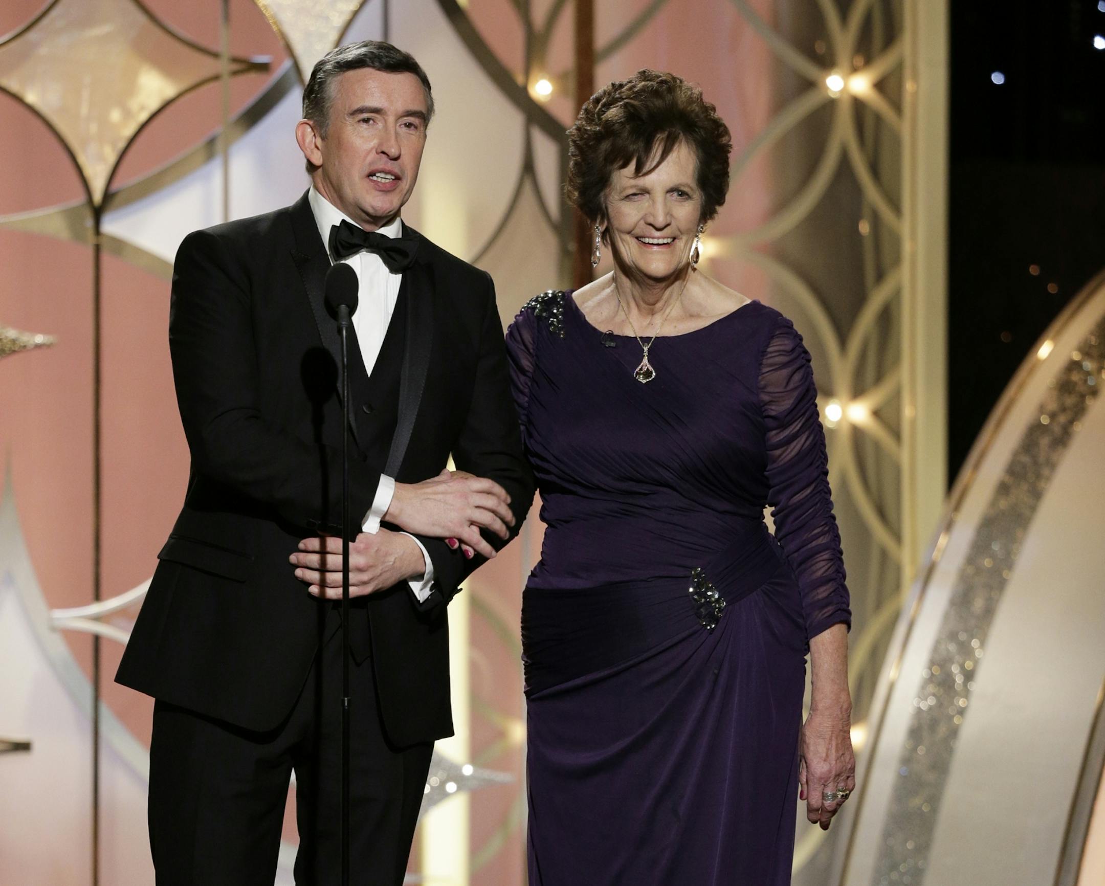 This image released by NBC shows actor Steve Coogan , left, and Philomena Lee, the inspiration for the film "Philomena" during the 71st annual Golden Globe Awards at the Beverly Hilton Hotel on Sunday, Jan. 12, 2014, in Beverly Hills, Calif.