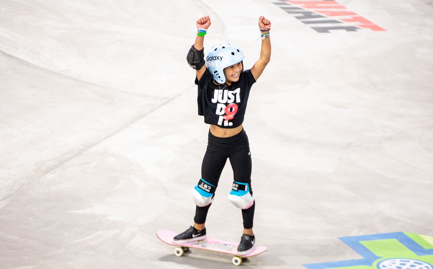 Sky Brown, 11, celebrates after maxing out her time on her first run during the Women's Skateboard Park qualifier round at the X Games at U.S. Bank Stadium