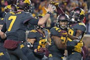Minnesota's wide receiver Rashad Still, right, celebrated a touchdown with teammates Mitch Leidner, left, and Rodney Smith, center, in the second quar