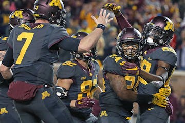 Minnesota's wide receiver Rashad Still, right, celebrated a touchdown with teammates Mitch Leidner, left, and Rodney Smith, center, in the second quar