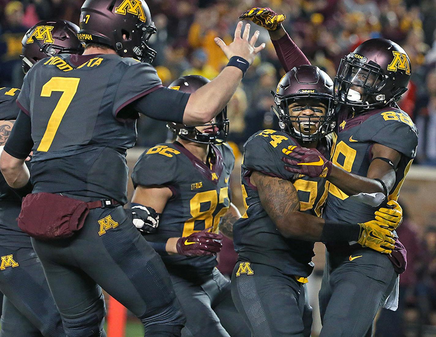 Minnesota's wide receiver Rashad Still, right, celebrated a touchdown with teammates Mitch Leidner, left, and Rodney Smith, center, in the second quarter as Minnesota took on Michigan at TCF Bank Stadium, Saturday, October 31, 2015 in Minneapolis, MN.