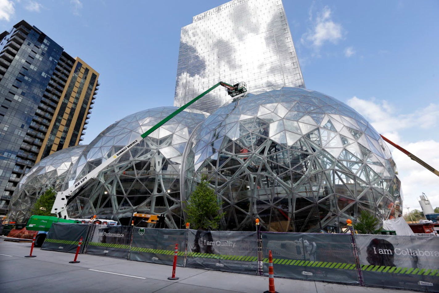 FILE - In this April 27, 2017 file photo, construction continues on three large, glass-covered domes as part of an expansion of the Amazon.com campus in downtown Seattle. Amazon said Thursday, Sept. 7, that it will spend more than $5 billion to build another headquarters in North America to house as many as 50,000 employees. It plans to stay in its sprawling Seattle headquarters and the new space will be "a full equal" of its current home, said founder and CEO Jeff Bezos. (AP Photo/Elaine Thomps