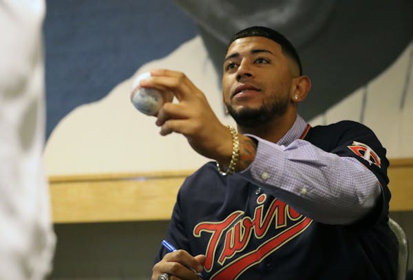 Minnesota Twins pitcher Fernando Romero handed a baseball back to its owner after he autographed it at TwinsFest. ] Shari L. Gross &#x2022; shari.gros
