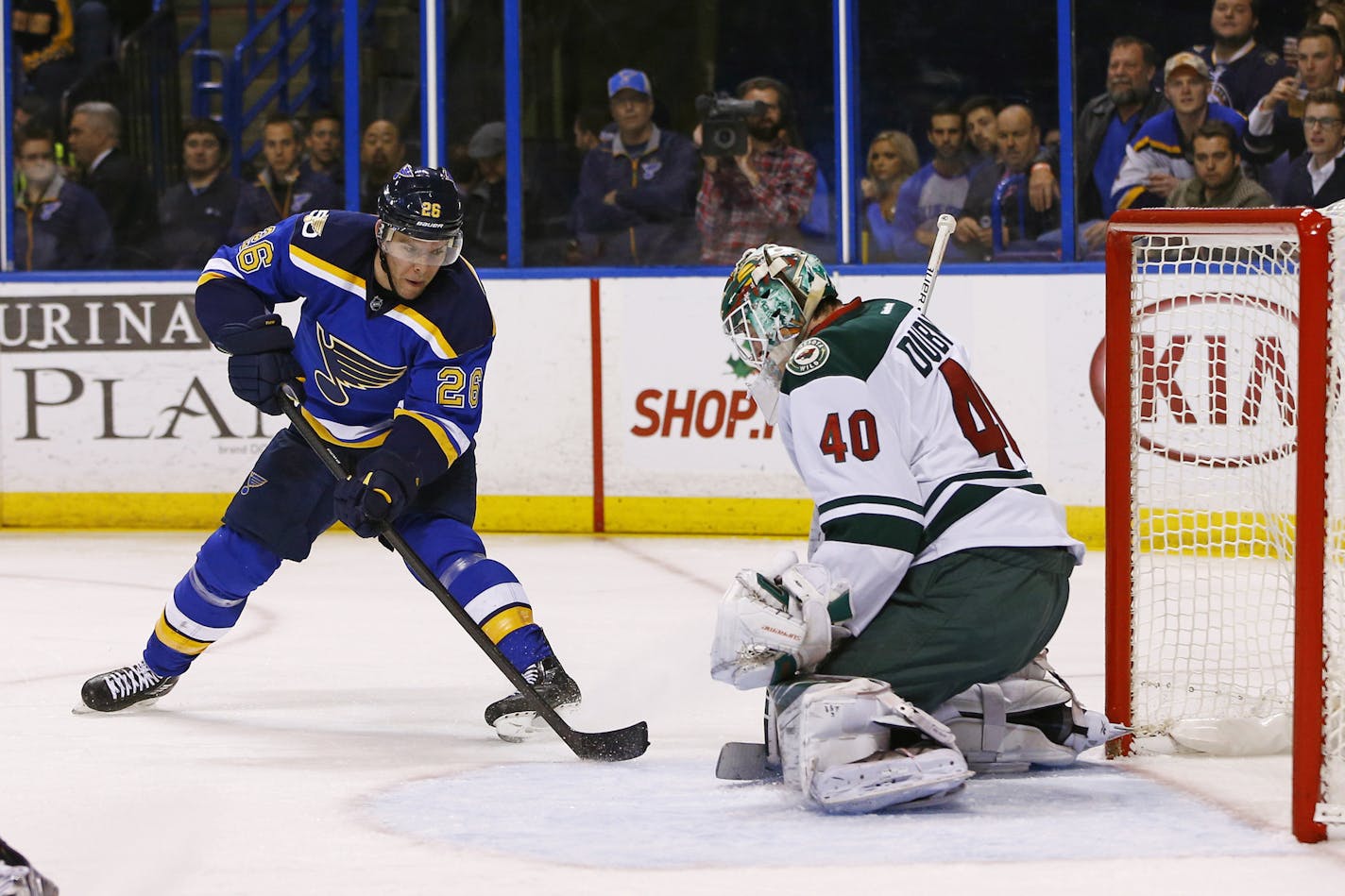 St. Louis Blues' Paul Stastny, left, has his shot blocked by Minnesota Wild goalie Devan Dubnyk during the second period of an NHL hockey game Saturday, Nov. 26, 2016, in St. Louis. (AP Photo/Billy Hurst)