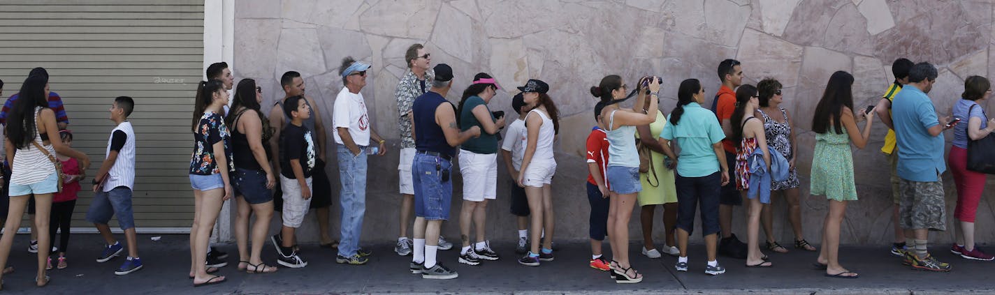 People wait in line to enter the Gold & Silver Pawn Shop in Las Vegas Monday, July 28, 2014, in Las Vegas. Rick Harrison, owner of the pawn shop and one of the stars of the reality television series Pawn Stars, has proposed building a shopping plaza on land nearby. (AP Photo/John Locher)