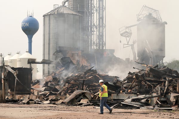 Salvage crews and volunteer firefighters cleaned up the charred pile that was the Clinton Grain Elevator on Monday morning.