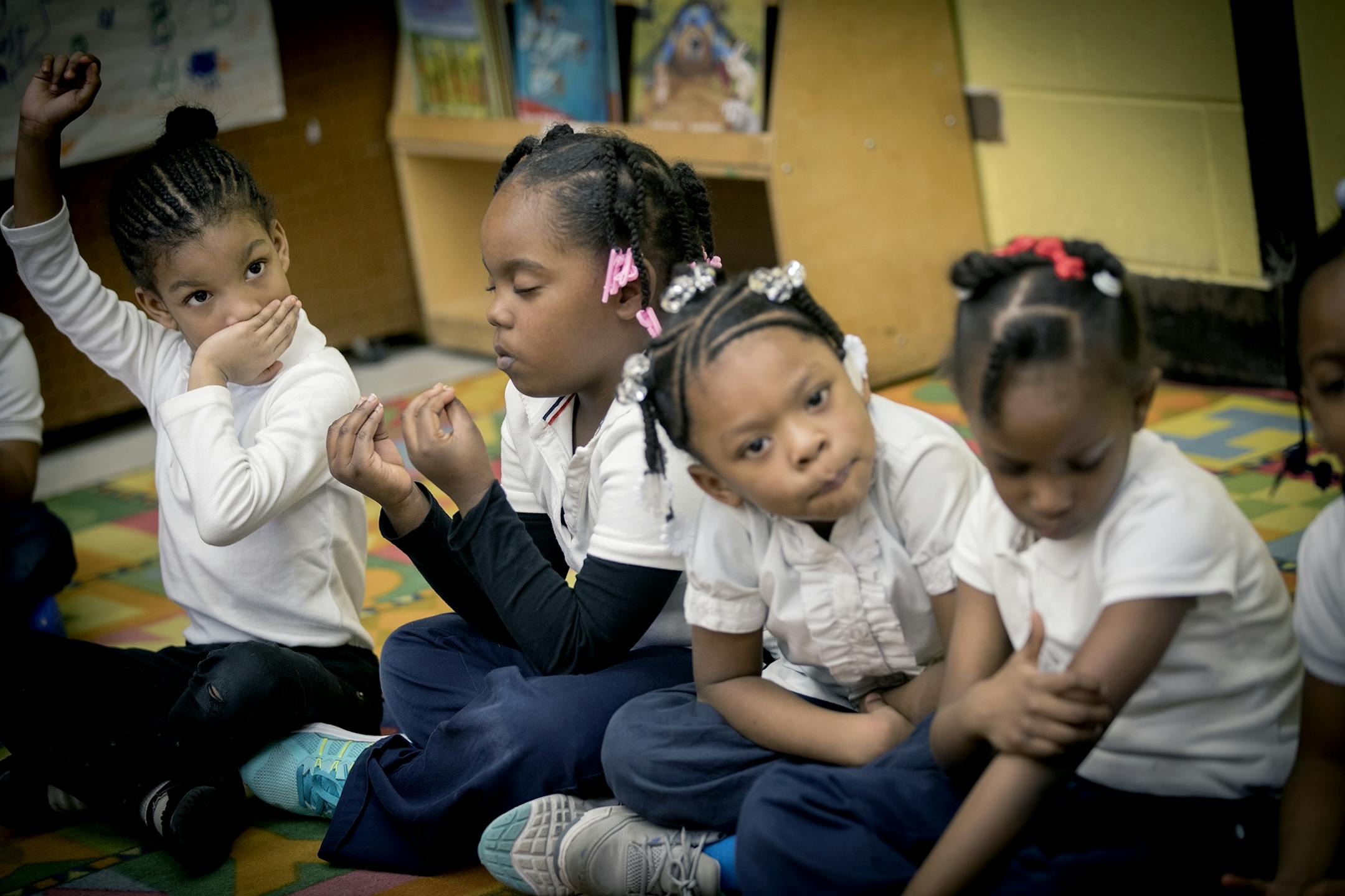 A pre-k students at Marcus Garvey Elementary School turned to yoga to calm her surroundings during a class activity, Tuesday, March 21, 2017 in Chicago, IL.