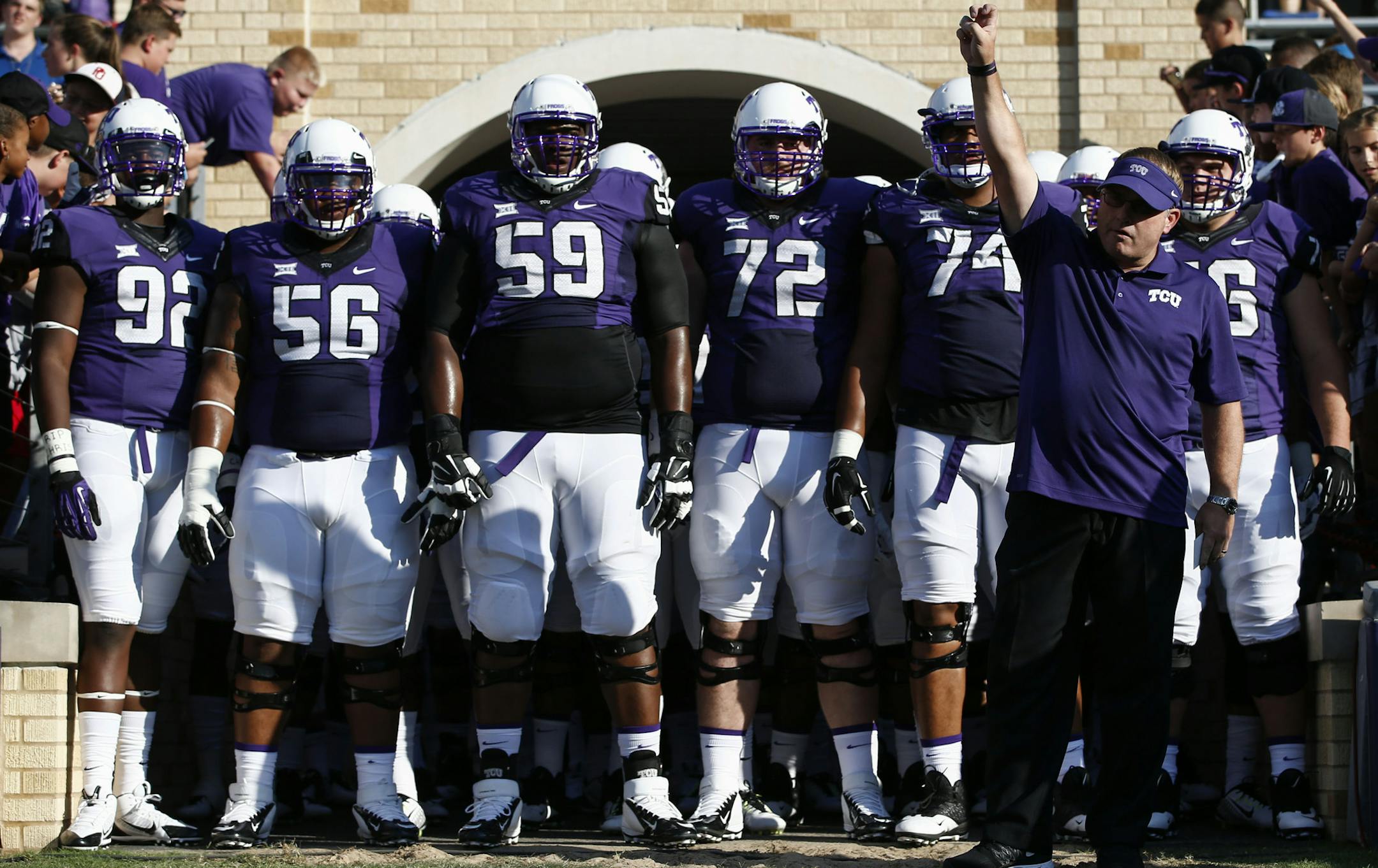 TCU head coach Gary Patterson salutes the crowd as he prepares to lead his team onto the field against Samford before an NCAA college football game in Fort Worth, Texas, Saturday, Aug. 30, 2014. (AP Photo/Jim Cowsert) ORG XMIT: TXJC1xx