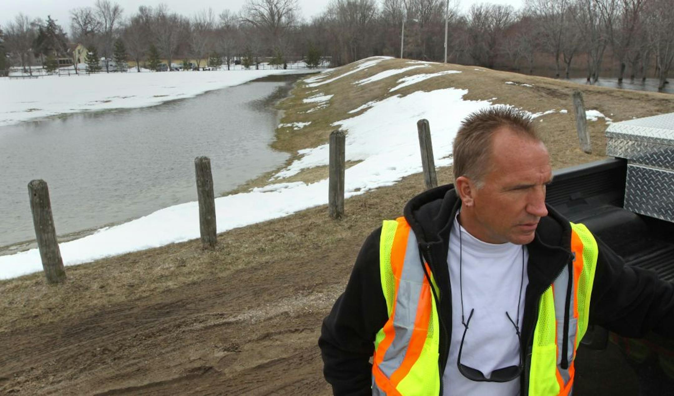 Delano Mayor Dale Graunke surveyed the earthen dikes built in 1969 in the central park area of the town. The dikes are leaking water from the south fork of the Crow River. Cities all over Minnesota are relying on earthen dikes built more than 40 years ago to protect them against high waters.