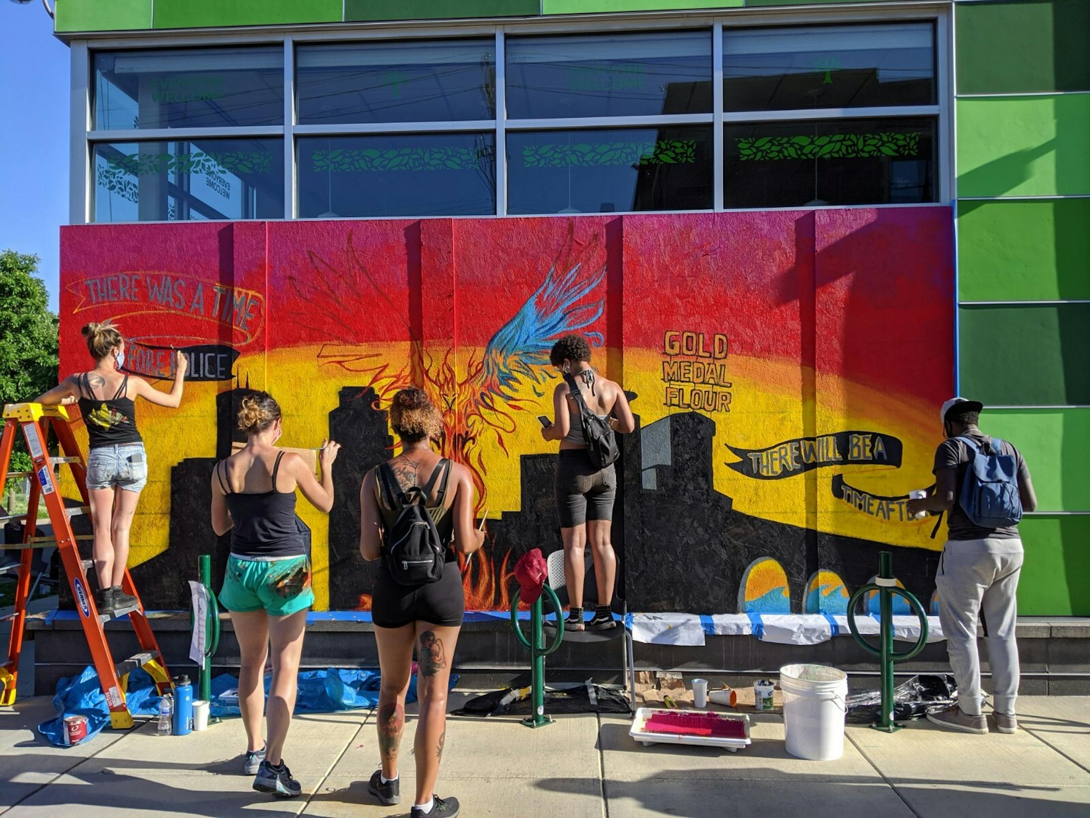 Artists Juliette Myers, Leslie Barlow, Nell Pierce, Maria Robinson and Hussain Ali worked on a mural at the Seward Co-op (317 E. 38th St.) referencing rebirth and reconciliation following the killing of George Floyd by police.