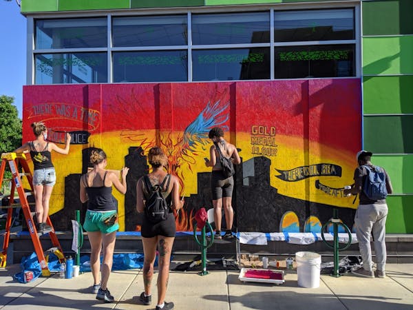 Artists Juliette Myers, Leslie Barlow, Nell Pierce, Maria Robinson and Hussain Ali worked on a mural at the Seward Co-op (317 E. 38th St.) referencing