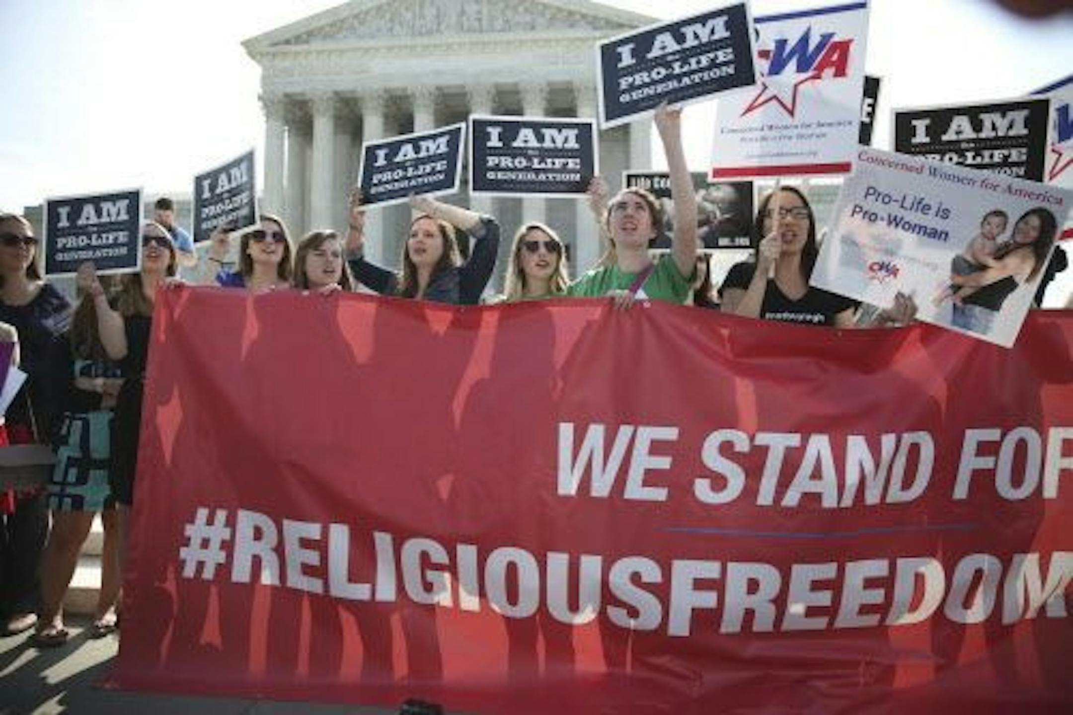 Activists gather outside the Supreme Court building Monday morning in Washington, June 30, 2014.