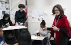 Minnesota's new education commissioner, Mary Cathryn Ricker, (in red) talked with students at she toured Hopkins West Junior High with during a listen