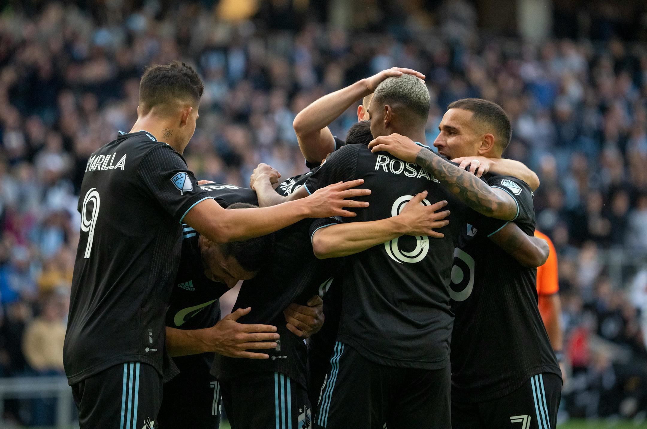 His teammates smothered Minnesota United midfielder Jonathan Gonzalez (6) after he scored on Vancouver Whitecaps goalkeeper Thomas Hasal in the second half of their game.