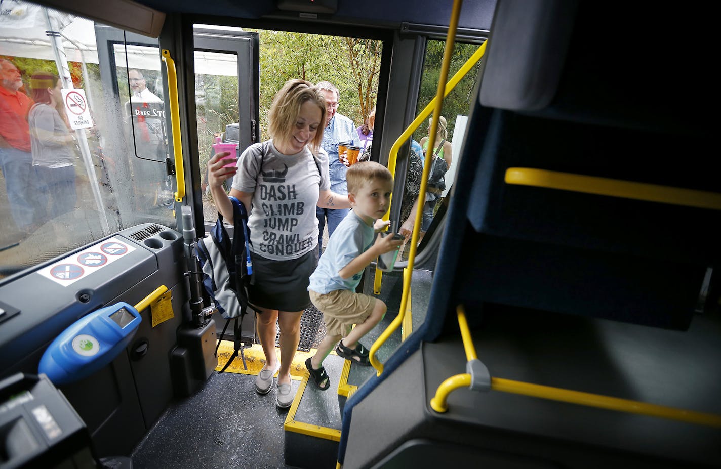 Passengers en route to the State Fair made their way onto a Southwest Transit double decker bus, Friday, August 29, 2014 in Eden Prairie, MN. The company is running the first double decker buses in the Twin Cities. They've wanted them for awhile but couldn't get because none were made in the US. ] (ELIZABETH FLORES/STAR TRIBUNE) ELIZABETH FLORES &#x2022; eflores@startribune.com