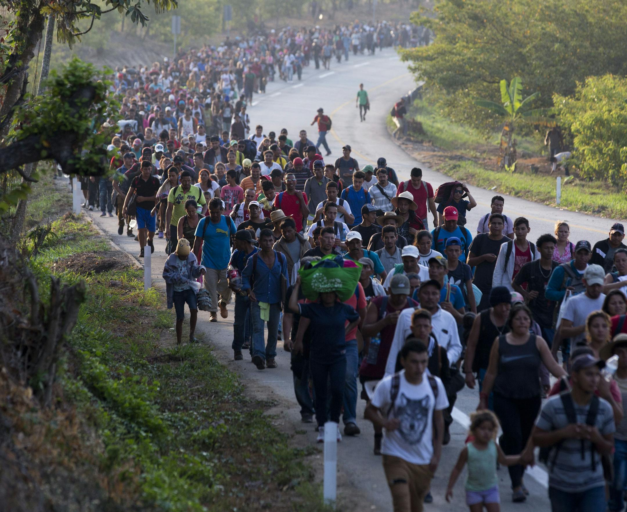 Central American migrants, part of a caravan hoping to reach the U.S. border, move on the road in Escuintla, Chiapas State, Mexico, Saturday, April 20, 2019. Thousands of migrants in several different caravans have been gathering in Chiapas in recent days and weeks. (AP Photo/Moises Castillo)